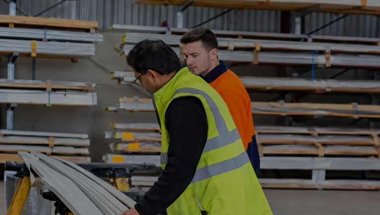 Event crew members wearing high-visibility vests coordinating equipment setup at a venue