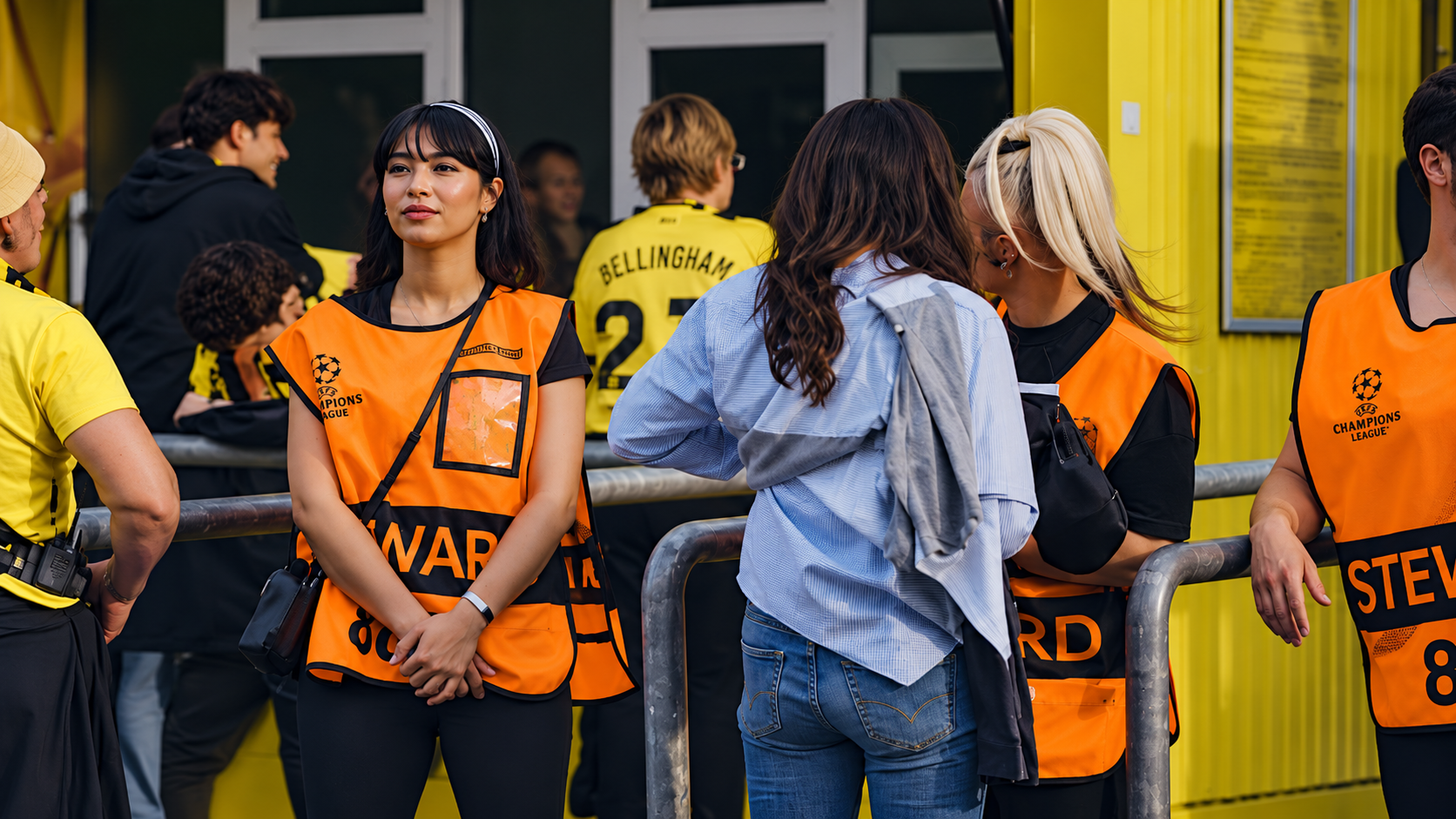 Event staff for hire assisting attendees at a live sporting event entrance